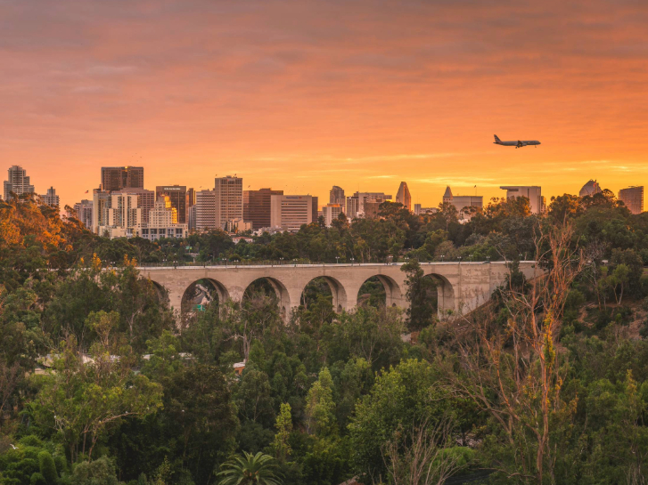 Plane Flying Over Downtown and Balboa Park at Sunset